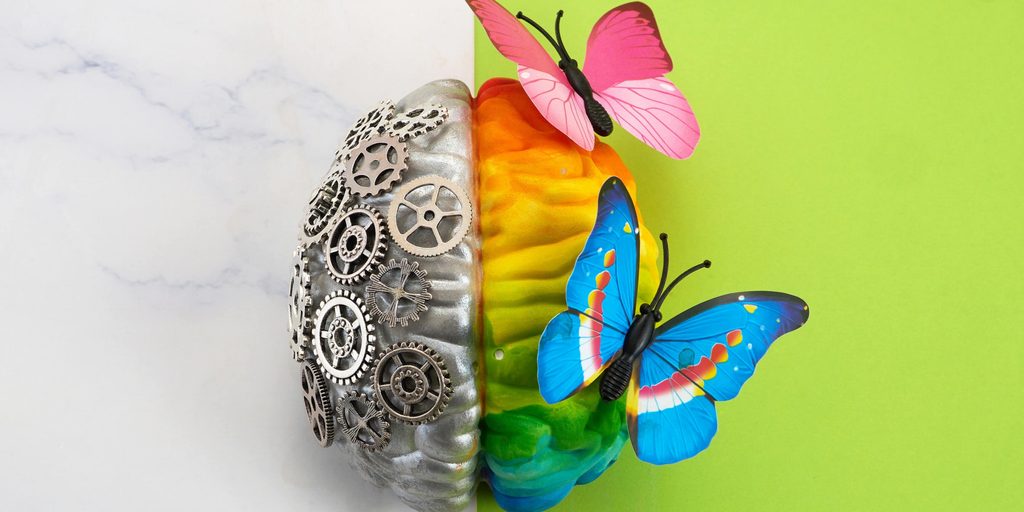 A colourful model brain with gears on one side and butterflies on the other, illustrating young-onset dementia risk factors, brain health and the potential to influence modifiable areas of health and lifestyle.