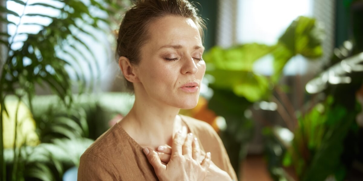 Woman practising a calm breathing exercise with her eyes closed